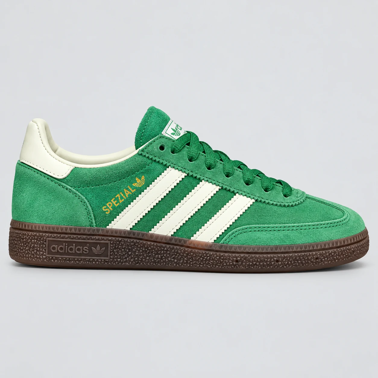 adidas Handball Spezial — Green / White / Brown Green / White / Brown low-top sneaker with lace-up fastening, layered panels and three-stripe detailing. Browse the cleaned catalogue image and original supplier photo, and select your UK size from 3 to 9.