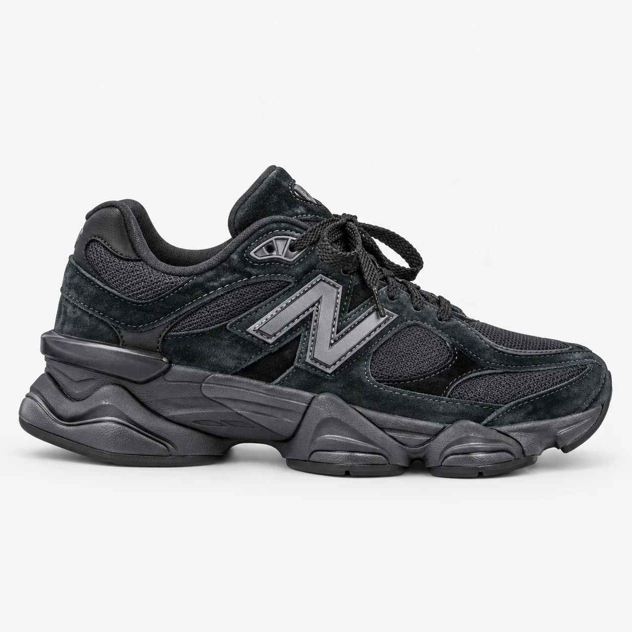 New Balance 9060 — Black Black low-top sneaker with lace-up fastening, layered panels and visible N branding. Browse both the cleaned catalogue image and original supplier photo, and select your UK size from 3 to 9.