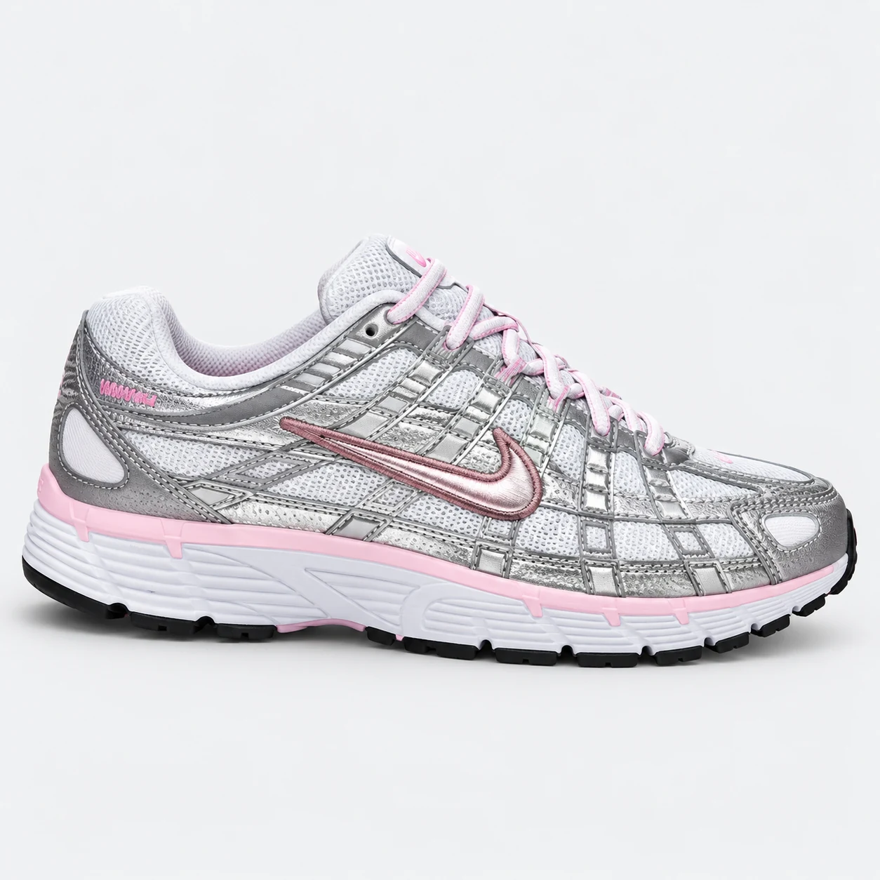 Nike P-6000 — Silver / White / Pink Silver / White / Pink low-top sneaker with lace-up fastening, layered panels and visible Swoosh branding. Browse the cleaned catalogue image and original supplier photo, and select your UK size from 3 to 9.
