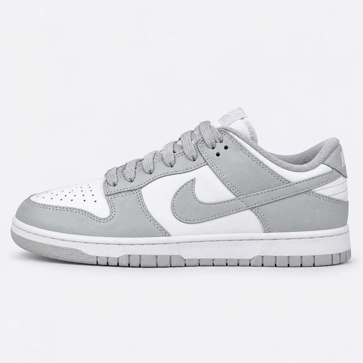 Nike Dunk Low — White / Light Grey White / Light Grey low-top sneaker with lace-up fastening, layered panels and visible Swoosh branding. Browse the cleaned catalogue image and original supplier photo, and select your UK size from 3 to 9.