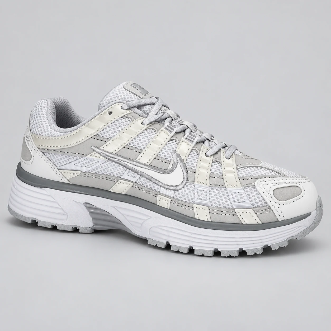 Nike P-6000 — White / Light Grey A white and light grey low-top sneaker with mesh-textured panels, layered strips, matching laces and a grey band above the white sole. Choose a UK size from 3 to 9 and view the product photos at The Drip Society.